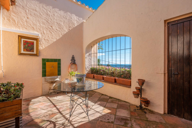 Attractive patio with sea views in a Mediterranean style villa.