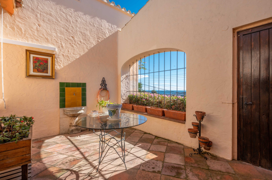 Attractive patio with sea views in a Mediterranean style villa.